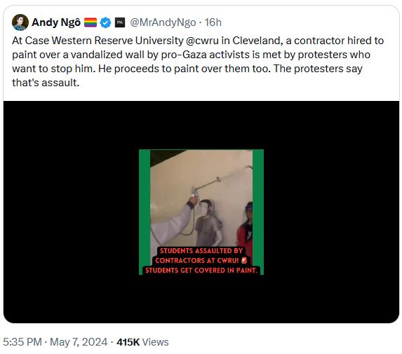 Crew cleaning campus protest graffiti spray paint over pro-Hamas protestors blocking them