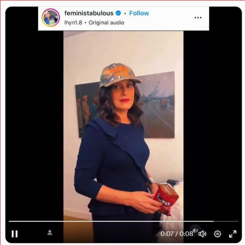 NextImg:Whitmer mocks Catholicism in a Harris/Walz cap, dispensing a Dorito as a 'Eucharist' to a leftist internet 'influencer'
