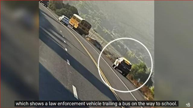 Sheriff car trailing school bus on San Diego County border towns of Jamul and Dulzera after migrants tried to board bus.