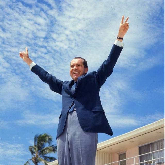 Richard Nixon, flashing the victory sign.